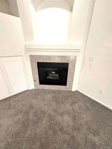 a view of empty room with a fireplace
