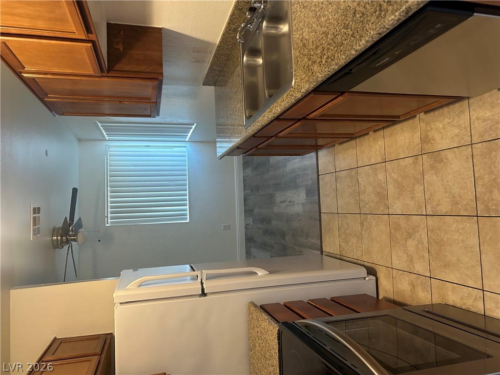 1852 North Decatur Boulevard, Unit 103 Las Vegas, NV 89108 - Photo 2 of 10 Functional kitchen with ample cabinet space, granite countertops, and dual basin sink.