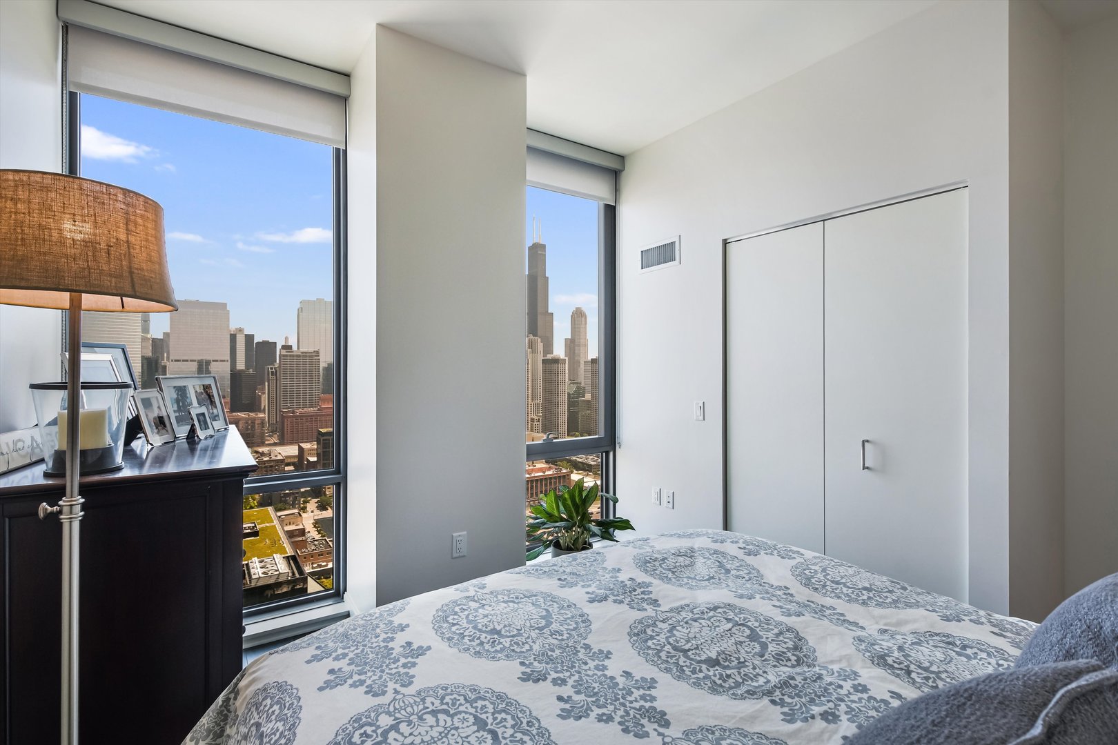 164 North Peoria Street, Unit 4004 Chicago, IL 60607 - Photo 19 of 32 a bedroom with a bed and a mirror