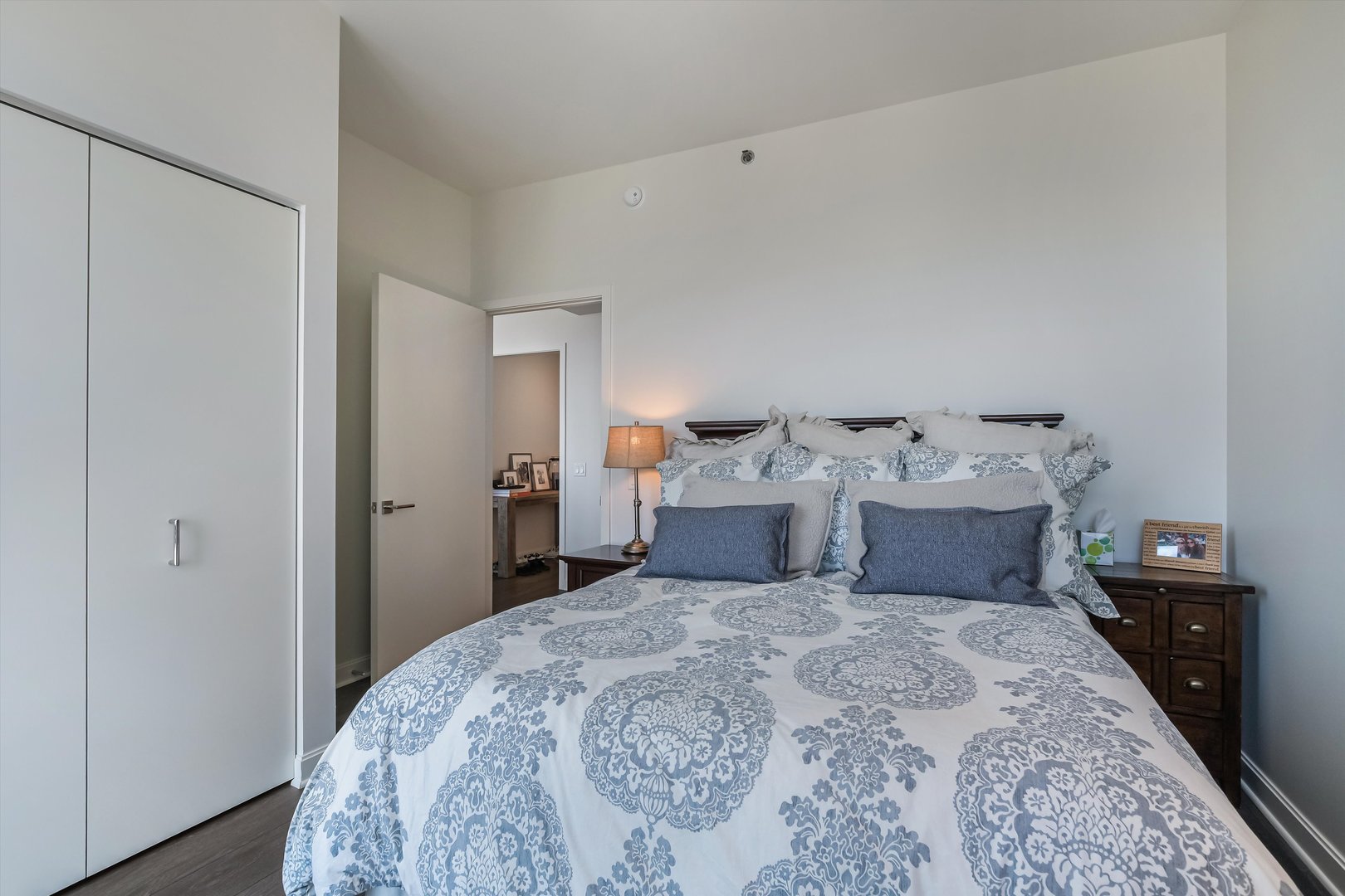 164 North Peoria Street, Unit 4004 Chicago, IL 60607 - Photo 20 of 32 a bedroom with bed and wooden floor