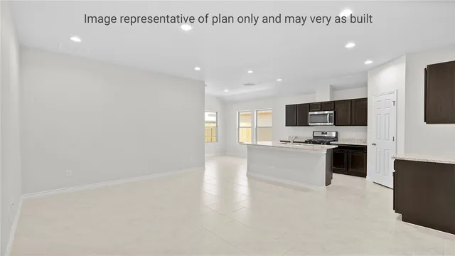 a large kitchen with a large counter top appliances and cabinets