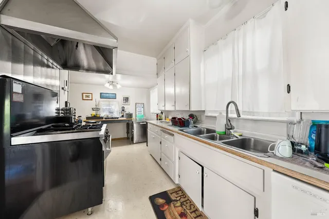 a kitchen with stainless steel appliances granite countertop a stove and a sink
