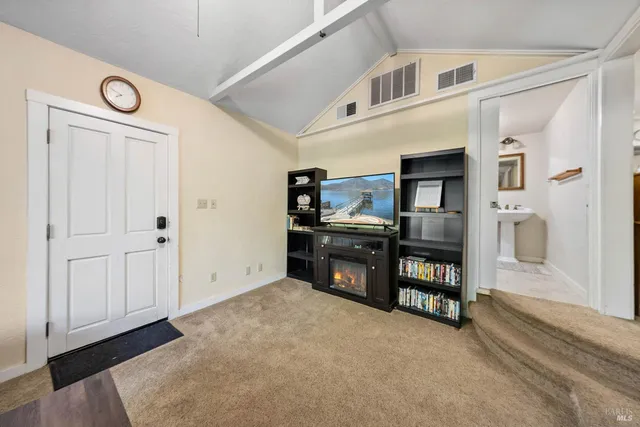 a view of kitchen with furniture and refrigerator