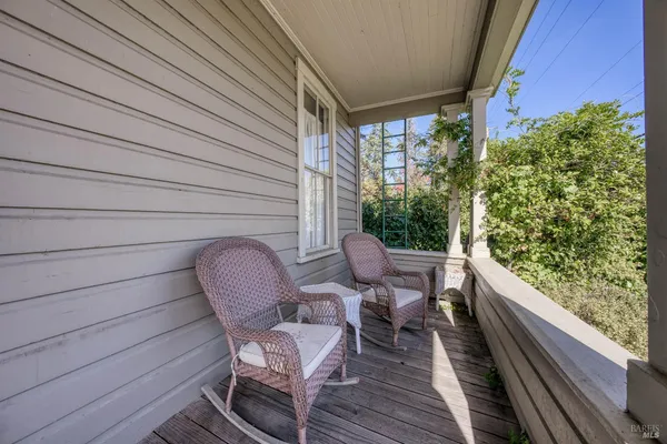 a balcony with table and chairs