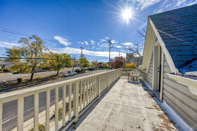 a view of a house with a big yard and potted plants