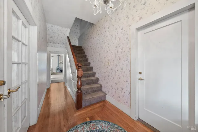 a view of a hallway with closet and a window