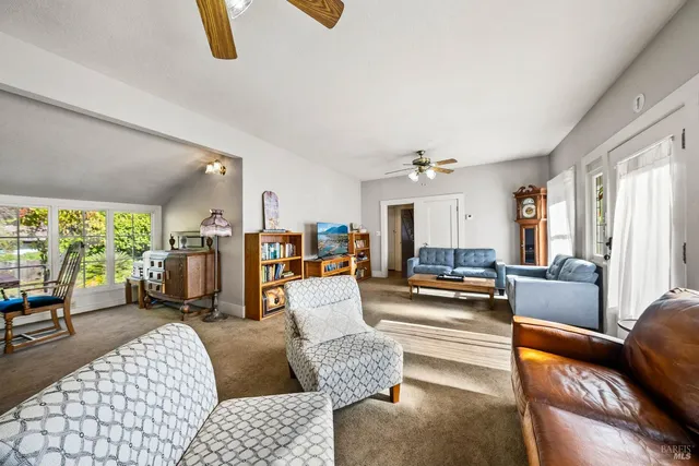 a view of a dining room with furniture and a window