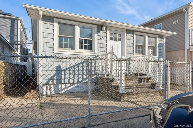 a view of a house with wooden fence