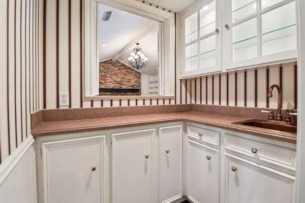 a kitchen with stainless steel appliances a refrigerator and a wooden floor