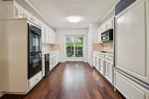 a kitchen with stainless steel appliances a refrigerator and a stove top oven