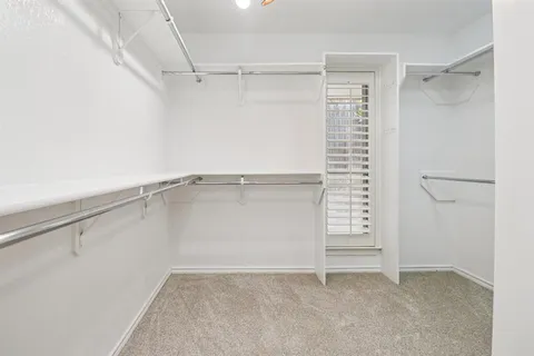 a bathroom with a double vanity sink a mirror and a bathtub