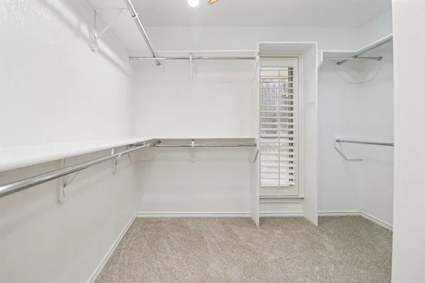 a bathroom with a double vanity sink a mirror and a bathtub