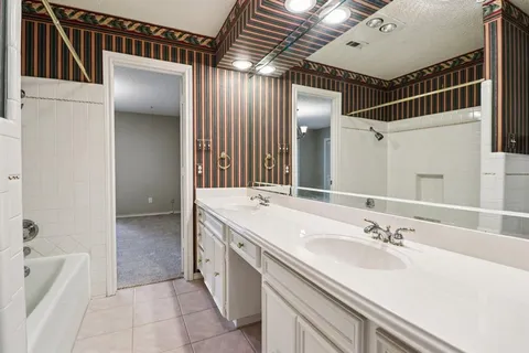 a bathroom with a bathtub and shower