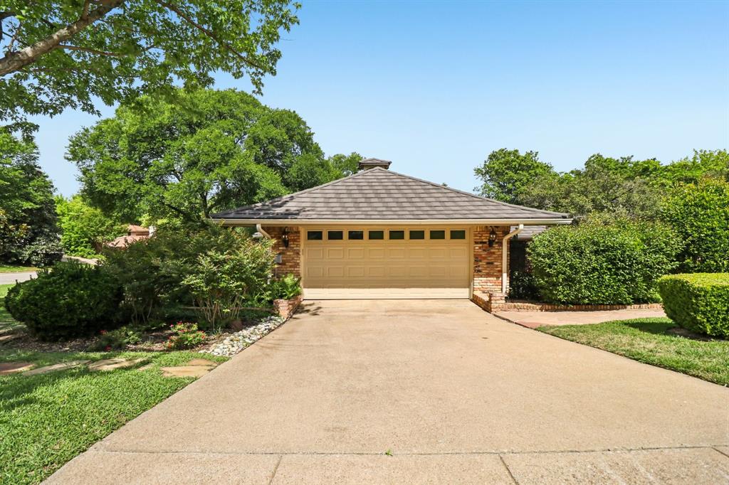 1015 Crowley Road Arlington, TX 76012 - Photo 34 of 36 a front view of a house with a yard and garage