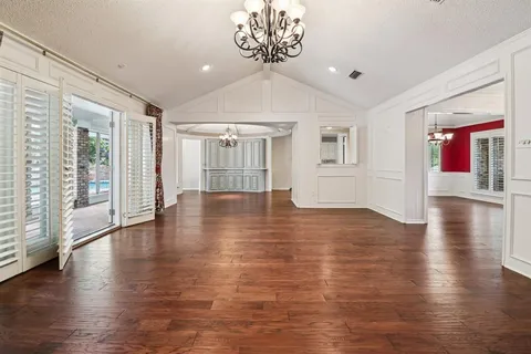a living room with a fireplace a flat screen tv and a wooden floor