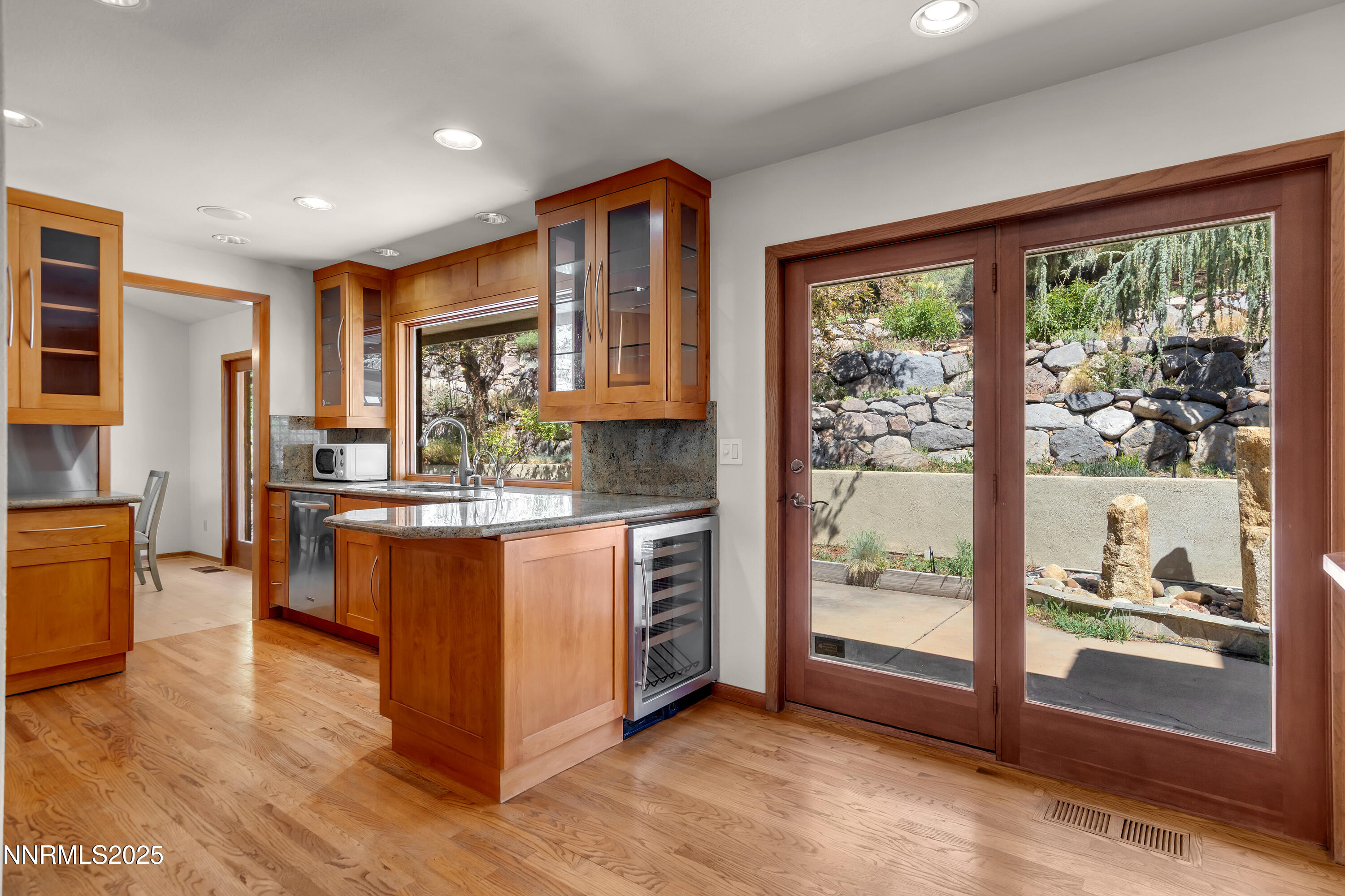 2593 Chaparral Court Reno, NV 89509 - Photo 12 of 37 a kitchen with stainless steel appliances granite countertop a refrigerator a stove top oven and a sink with large window