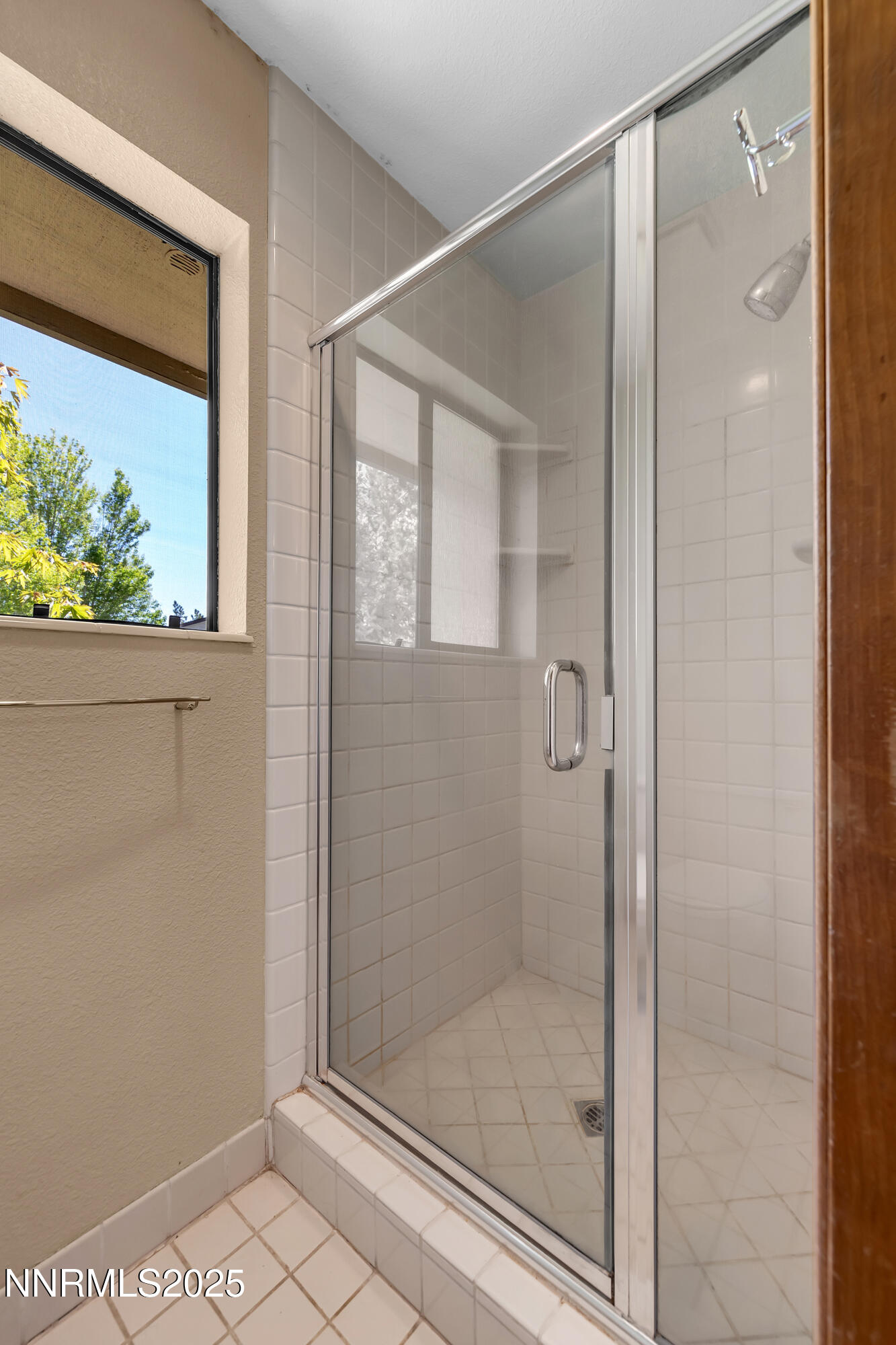 2593 Chaparral Court Reno, NV 89509 - Photo 22 of 37 a bathroom with a glass shower door