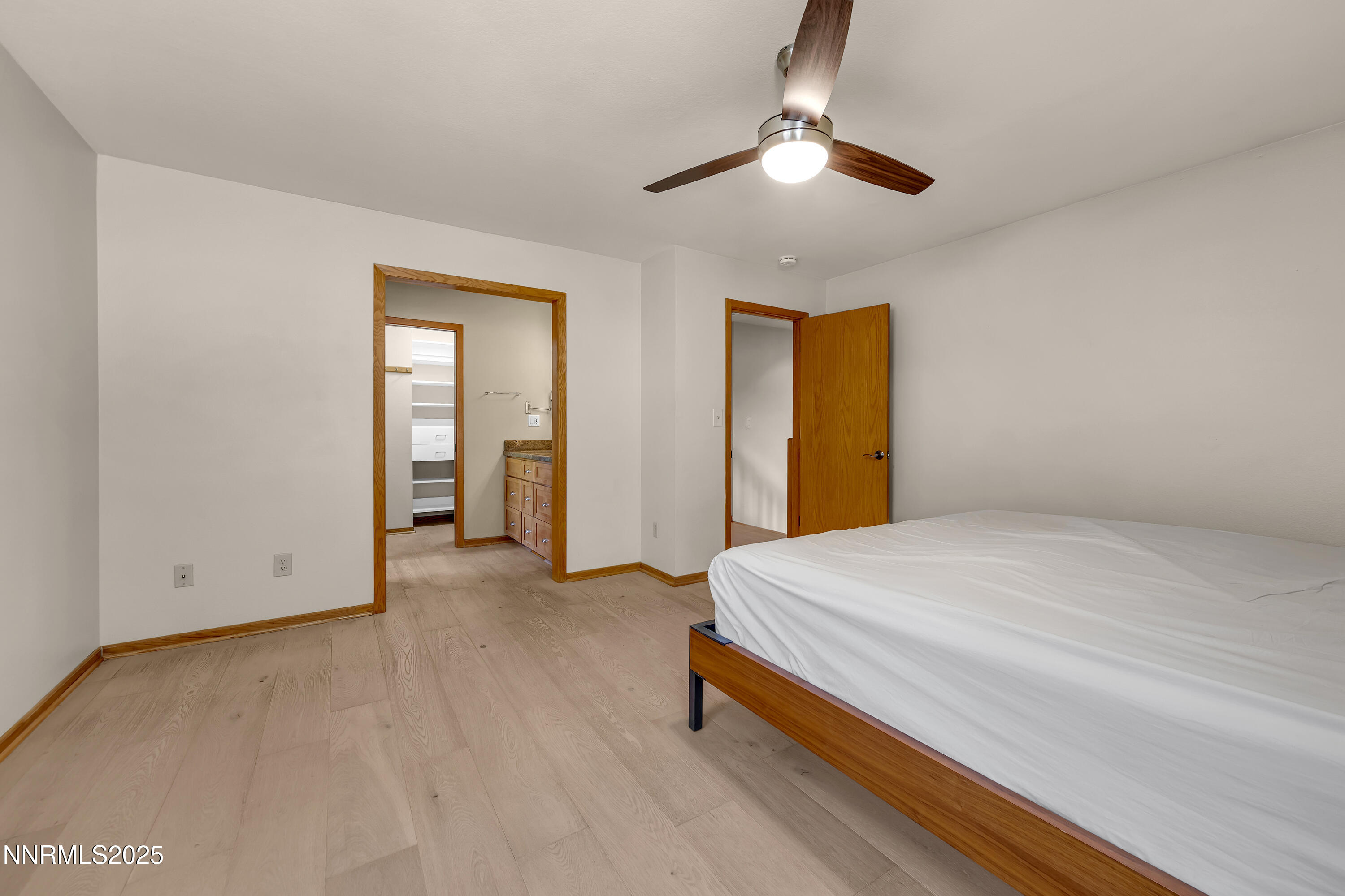 2593 Chaparral Court Reno, NV 89509 - Photo 27 of 37 a bedroom with a bed and a chandelier