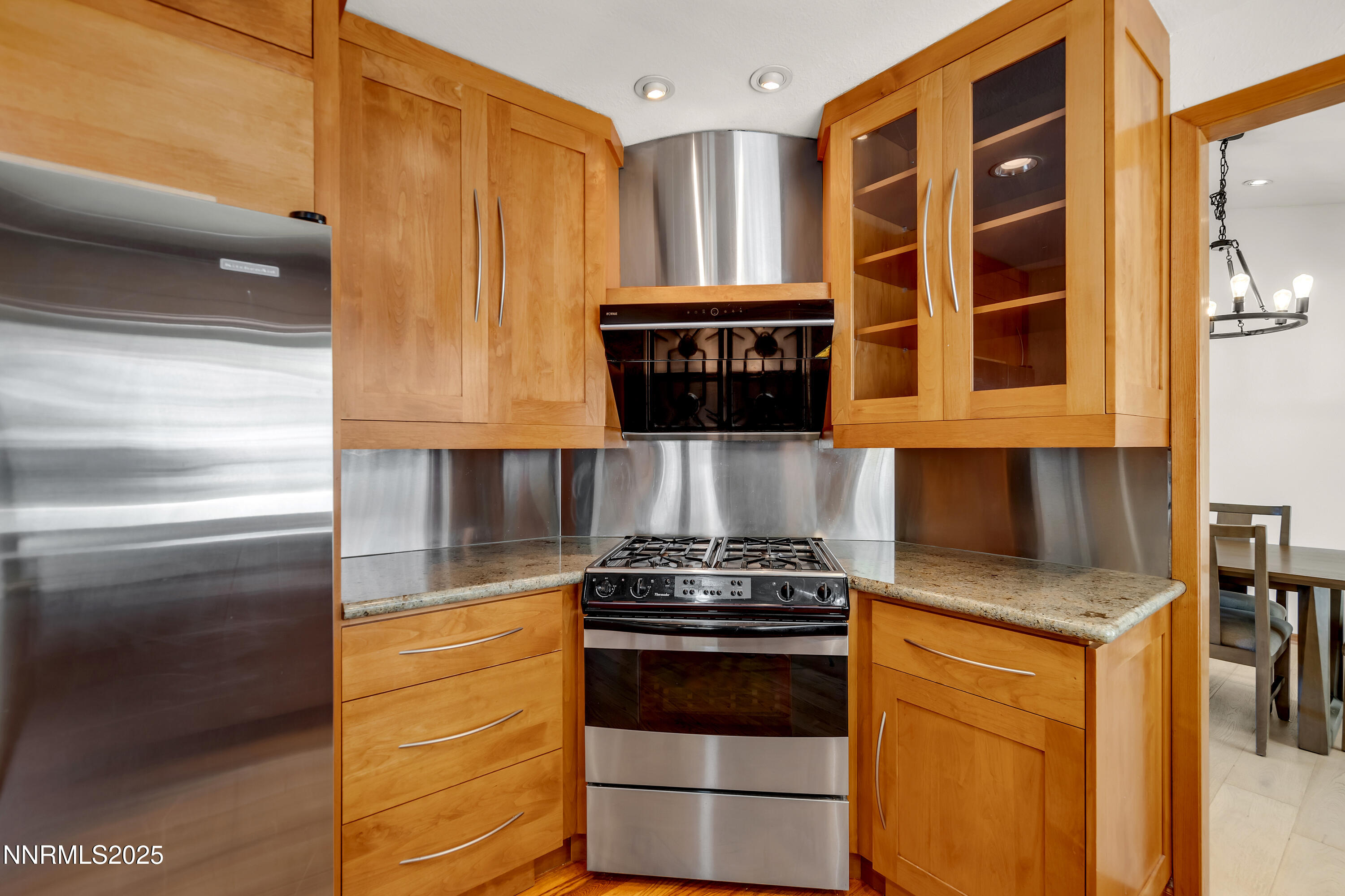 2593 Chaparral Court Reno, NV 89509 - Photo 10 of 37 a kitchen with stainless steel appliances granite countertop a stove and a microwave