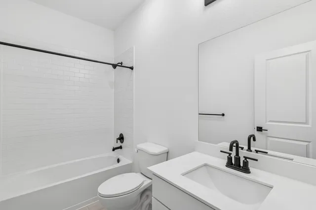 a bathroom with a sink a toilet and a tub