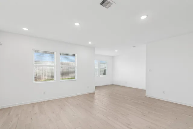 an empty room with a empty space and windows