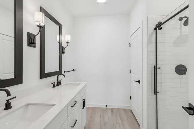 a bathroom with a sink and a mirror with bathtub