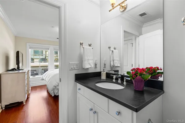 a kitchen with white cabinets and chandelier