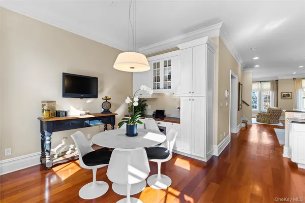 a view of a dining room with furniture wooden floor and chandelier