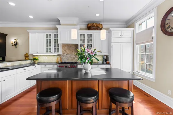 a kitchen with stainless steel appliances granite countertop a sink and a refrigerator