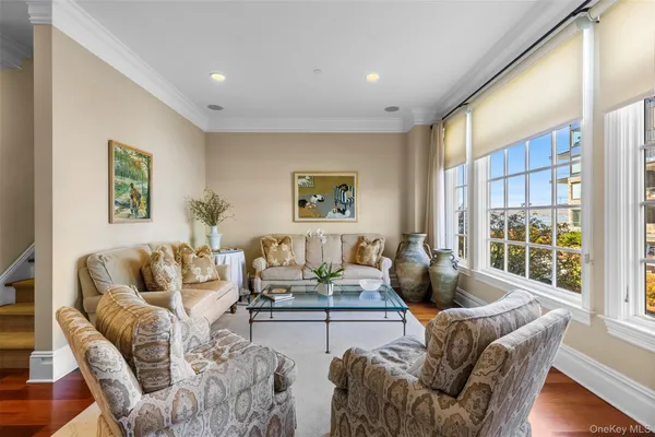 a living room with furniture and large window