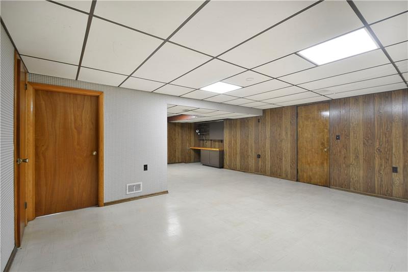 459 Marzolf Road Pittsburgh, PA 15209 - Photo 15 of 25 Full/finished basement. Doors on the left are the 2nd full bathroom and laundry/utility room. Door on the far wall is to the garage.