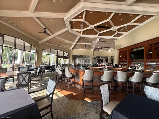a view of a tennis ground with large trees