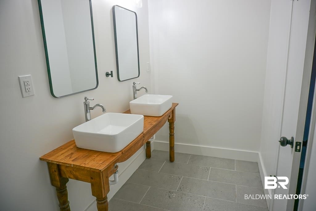 6205 Zeigler Boulevard Mobile, AL 36608 - Photo 14 of 17 Bathroom with a sink and tile patterned floors