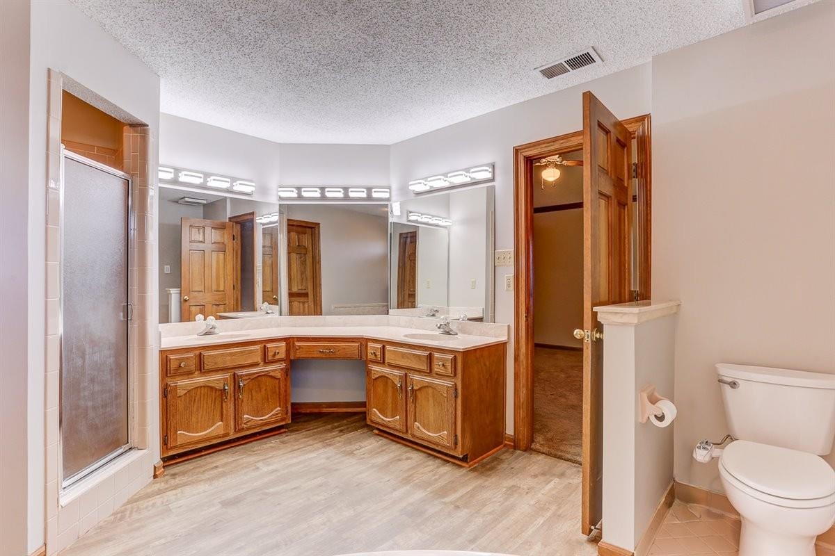 3915 Oak Road Bartlett, TN 38135 - Photo 13 of 28 a spacious bathroom with a granite countertop sink and a mirror