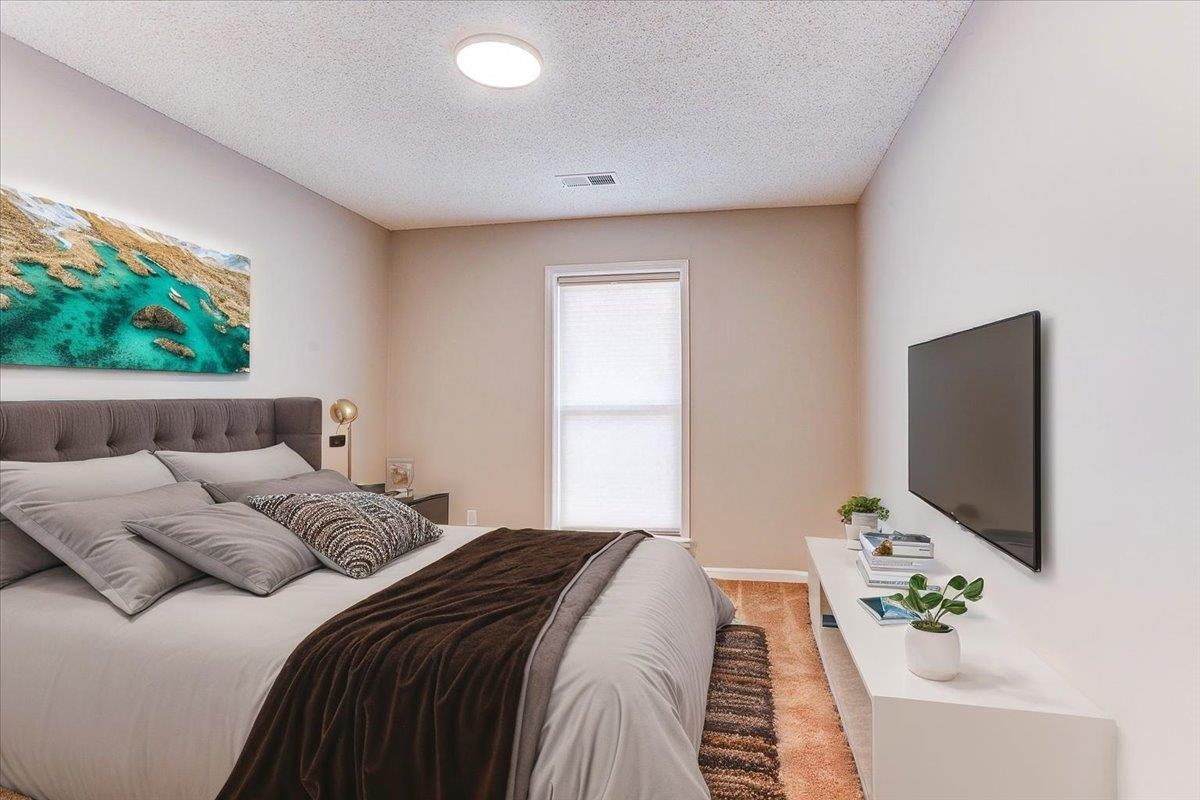 3915 Oak Road Bartlett, TN 38135 - Photo 14 of 28 a bedroom with a bed and a flat screen tv