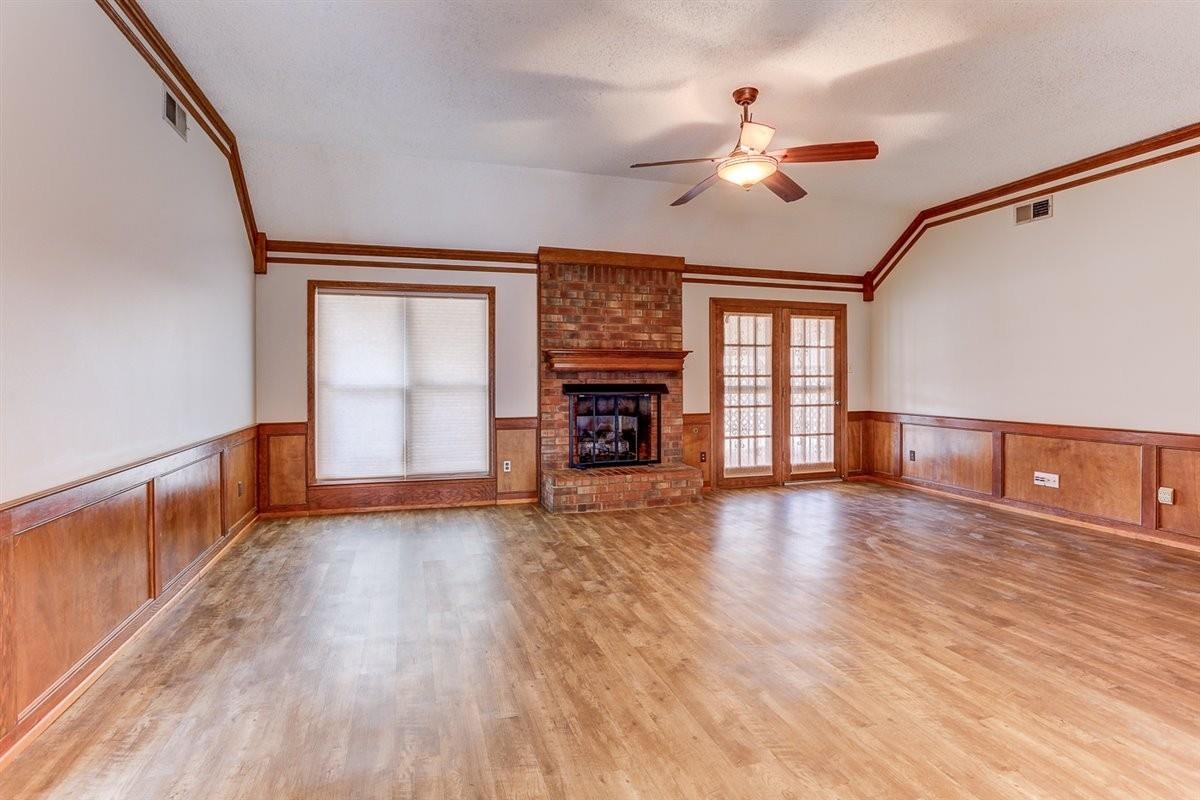 3915 Oak Road Bartlett, TN 38135 - Photo 15 of 28 a view of an empty room with wooden floor fireplace and a window