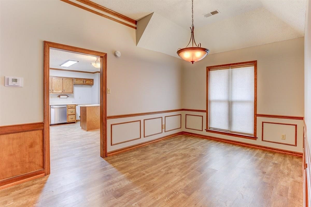 3915 Oak Road Bartlett, TN 38135 - Photo 16 of 28 a view of an empty room with wooden floor and a window
