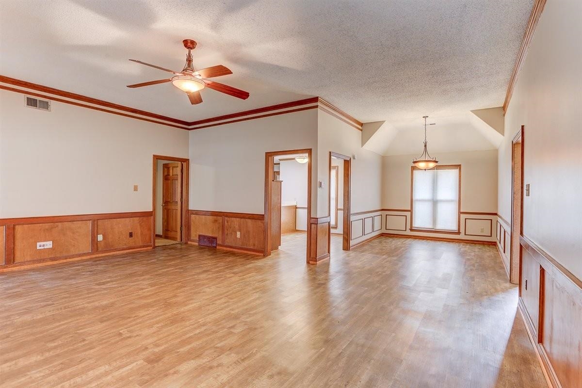 3915 Oak Road Bartlett, TN 38135 - Photo 18 of 28 a view of an empty room with wooden floor and a ceiling fan