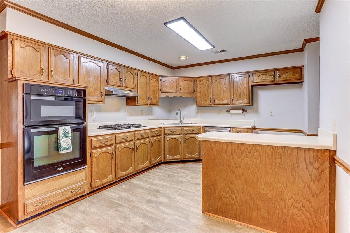 3915 Oak Road Bartlett, TN 38135 - Photo 19 of 28 a kitchen with stainless steel appliances granite countertop a refrigerator sink and cabinets