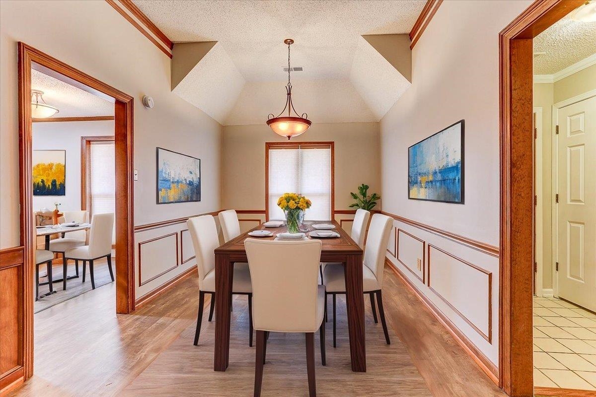 3915 Oak Road Bartlett, TN 38135 - Photo 3 of 28 Dining room featuring ornamental molding, a textured ceiling, light wood-style flooring, and wainscoting