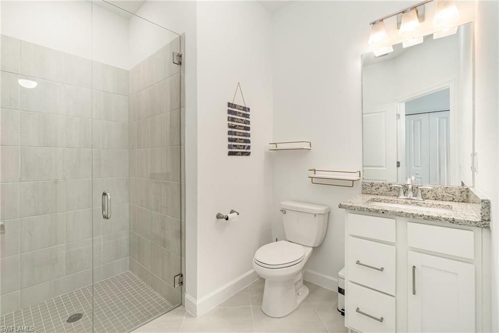 11127 Canopy Loop Fort Myers, FL 33913 - Photo 11 of 15 Bathroom featuring vanity, a shower stall, and light tile patterned flooring