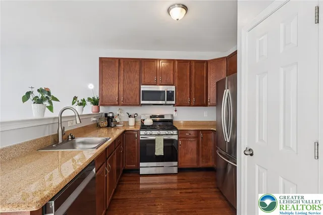 a kitchen with a sink stove top oven and microwave