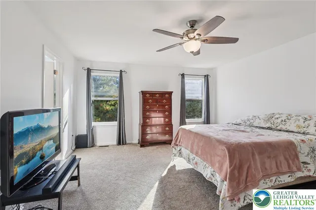 a bedroom with a bed and cabinet