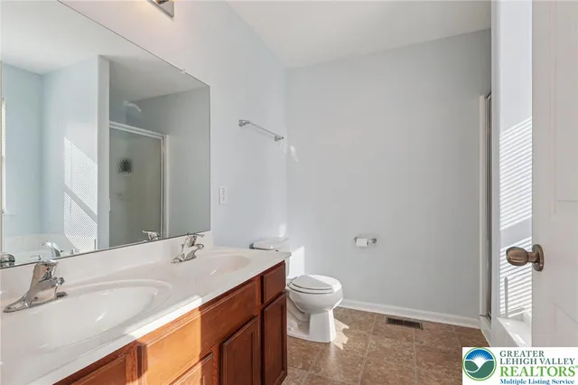 a bathroom with a tub sink and mirror