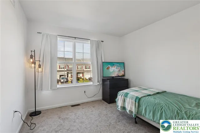 a living room with a couch and a rug