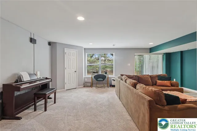 a living room with furniture and a piano