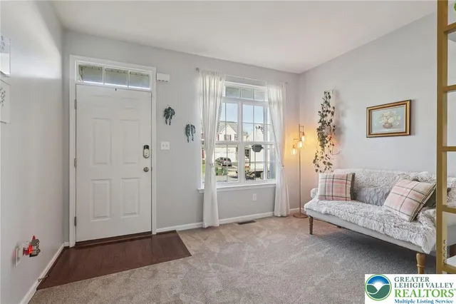 a living room with furniture and white walls