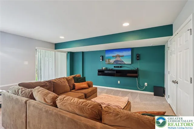 a living room with furniture a window and a potted plant