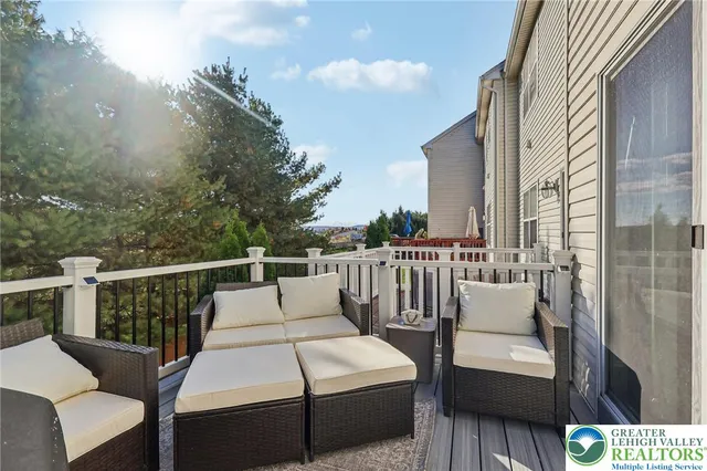 a living room with stainless steel appliances furniture and a kitchen view