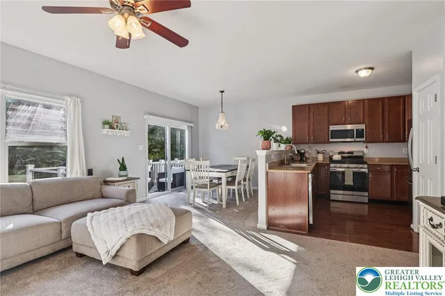 a kitchen with stainless steel appliances granite countertop a sink dishwasher and cabinets with wooden floor